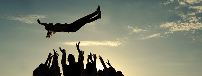 A woman is being tossed in the air by a trusted IT support department.